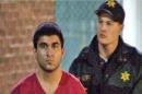 This late Saturday, Sept. 24, 2016, image from video by KIRO7 photographer Jeff Ritter shows suspected Cascade Mall shooter Arcan Cetin at Skagit County Jail in Mount Vernon, Wash., after his arrest in Oak Harbor, Wash., earlier in the evening. Investigators on Sunday tried to piece together information on the 20-year-old suspect in the deadly Washington state mall shootings who was apprehended after a nearly 24-hour manhunt. (Jeff Ritter/KIRO7.com via AP)