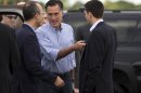 Republican presidential candidate, former Massachusetts Gov. Mitt Romney, center, talks with foreign policy adviser Dan Senor, left, and his vice presidential running mate, Rep. Paul Ryan, R-Wis., before boarding his campaign plane at Daytona International Airport, Saturday, Oct. 20, 2012, in Daytona Beach, Fla. (AP Photo/ Evan Vucci)
