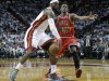 Miami Heat forward LeBron James, left, passes around Chicago Bulls forward Jimmy Butler during the first half of Game 1 of the NBA basketball playoff series in the Eastern Conference semifinals, Monday, May 6, 2013 in Miami. (AP Photo/Lynne Sladky)