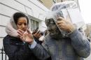 Domenico Rancadore covers his face as he leaves after an extradition hearing at Westminster Magistrates Court in central London