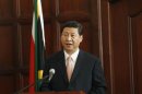 China's President Xi Jinping speaks during a media briefing at the presidential guest house in Pretoria