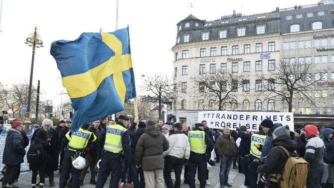 Stockholm police talk to participants of a movement called &quot;The People&#39;s Demonstration&quot; which held a protest at Norrmalmstorg square on January 30, 2016