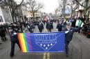 U.S. Rep. Seth Moulton, D-Mass., center without hat, marches with members of OutVets, a group of gay military veterans, during the St. Patrick's Day parade, Sunday, March 15, 2015, in Boston's South Boston neighborhood. Until now, gay rights groups have been barred by the South Boston Allied War Veterans Council from marching in the parade, which draws as many as a million spectators each year. (AP Photo/Steven Senne)