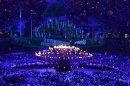 The Olympic Flame is lit during the opening ceremony at the Olympic Stadium