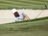 Richard Sterne of South Africa hits out of a bunker at the third green during the fourth and final round of the Dubai Desert Classic