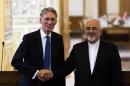 Iranian Foreign Minister Mohammad Javad Zarif (R) and his British counterpart Philip Hammond shake hands during a joint press conference in Tehran on August 23, 2015
