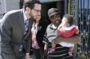 Alphonzo Jackson, center, holds his six-month old son Isaiah as he speaks with San Francisco Supervisor Scott Wiener, left, before a rally supporting paid family leave at City Hall in San Francisco, Tuesday, April 5, 2016. The San Francisco Board of Supervisors is voting on whether to require six weeks of fully paid leave for new parents - a move that would be a first for any jurisdiction. (AP Photo/Jeff Chiu)
