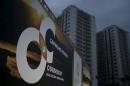 A banner of Odebrecht SA is pictured in front of buildings under construction at the Rio 2016 Olympic Games athletes village in Rio de Janeiro