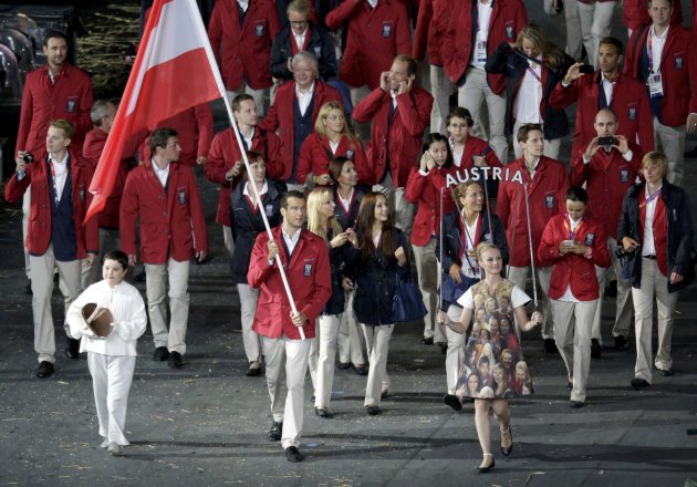 Austria's flag bearer Markus Rogan holds the national flag as he leads the contingent in the athletes parade during the opening ceremony of the London 2012 Olympic Games at the Olympic Stadium