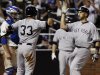 New York Yankees' Raul Ibanez, right, celebrates with teammate Nick Swisher (33) after hitting a three-run home run during the seventh inning of an interleague baseball game as New York Mets catcher Josh Thole looks on Saturday, June 23, 2012, in New York.  (AP Photo/Frank Franklin II)