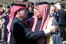 A picture released by the Jordanian Royal Palace shows King Abdullah II (L) greeting Safi, the father of Jordanian pilot Maaz al-Kassasbeh, on February 5, 2015 during a visit to offer his condolences to the family in Karak