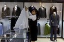 In this Sunday, May 19, 2013 photo, a North Korean woman works at a boutique shop which sells goods including Italian suits and Dior makeup at the newly-opened Haedanghwa Service Complex in Pyongyang, North Korea. U.N. sanctions are meant to stop the financing of North Korea's nuclear and missile programs but also aimed to sting the country's rich by crippling the import of luxury goods. (AP Photo/David Guttenfelder)