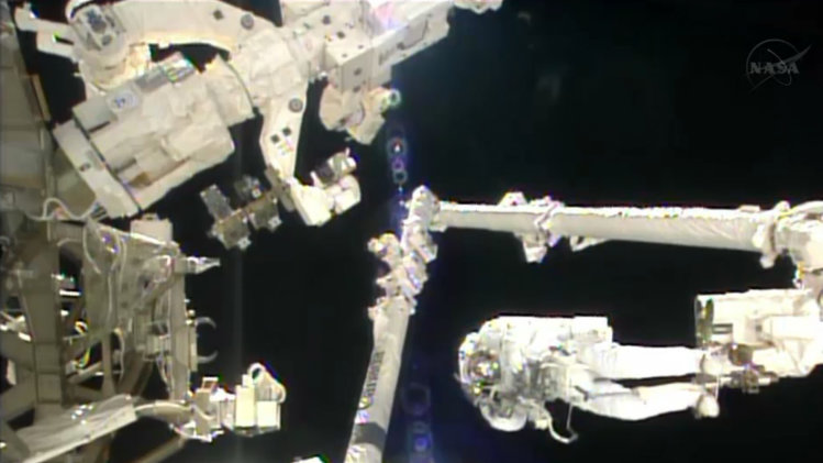 In this image made from video provided by NASA, Italian astronaut Luca Parmitano stands on the end of a robotic arm during a spacewalk outside the International Space Station on Tuesday, July 9, 2013. (AP Photo/NASA)