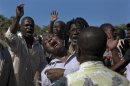 Supporters of former Haitian President Jean-Bertrand Aristide react outside a courthouse in Port-au-Prince