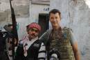 British photojournalist John Cantlie poses with a Free Syrian Army rebel in Aleppo