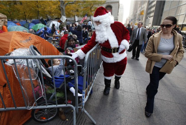 A man dressed as Santa Claus greets members of the "Occupy Wall Street" movement at the encampment in Zuccotti Park in New York