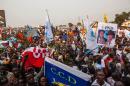 Opposition supporters hold banners, wave flags and cheer during a rally organised by political opposition parties in Kinshasa on July 31, 2016