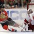 Detroit Red Wings goalie Jimmy Howard, right, saves a shot by Chicago Blackhawks' Jonathan Toews, left, during the second period of Game 5 of the NHL hockey Stanley Cup playoffs Western Conference semifinals in Chicago, Saturday, May 25, 2013. (AP Photo/Nam Y. Huh)