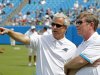 FILE - In this Aug. 4, 2012 file photo, Carolina Panthers' team president Danny Morrison, left, talks with general manager Marty Hurney during the NFL Carolina Panthers' Fan Fest football practice in Charlotte, N.C. The Panthers fired Hurney Monday, Oct. 22, 2012 following the team's 1-5 start this season. (AP Photo/Bob Leverone, File)