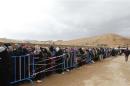Syrians, fleeing the violence from the Syrian town of Qara, queue to register to get help from relief agencies at the Lebanese border town of Arsal, in the eastern Bekaa Valley