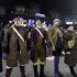 Patriot actors stand without their usual rifles to honor the victims of the Sandy Hook Elementary School shootings in Newtown, Conn., in the third quarter of an NFL football game between the New England Patriots and the San Francisco 49ers in Foxborough, Mass., Sunday, Dec. 16, 2012. (AP Photo/Elise Amendola)