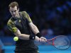 Britain's Murray hits a return to Switzerland's Federer during their men's singles semi-final tennis match at ATP World Tour Finals at O2 Arena in London