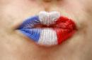 The lips of a French supporter are painted in the colors of the national flag, prior to the Euro 2016 Group A soccer match between France and Romania, at the Stade de France, in Saint-Denis, north of Paris, Friday, June 10, 2016. (AP Photo/Frank Augstein)