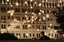 A couple look at the illuminated decoration to celebrate the festival season during Christmas eve in Hong Kong,Tuesday, Dec. 24, 2013. (AP Photo/Kin Cheung)