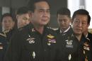 Thailand's Army commander Gen. Prayuth Chan-ocha, left, arrives at the Royal Thai Army Club in Bangkok, Thailand, Friday, June 13, 2014. The head of Thailand's military junta said Friday that an interim government would be set up by September, offering the most specific timeline yet on a possible transfer of power after last month's coup. (AP Photo/ASTV Manager newspaper) THAILAND OUT