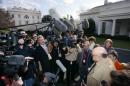 File Photo - Former Nixon Secretary of Defense Melvin Laird is surrounded by reporters outside the White House