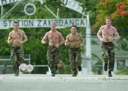 Four U.S. Navy seals jog at the Philippine Navy headquarters in Zamboanga City, in the southern Philippines June 17, 2002. REUTERS/str