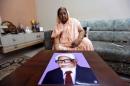 Zakia Jafri shows a photograph of her late husband Ehsan Jafri at her son's house in Surat