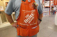 <p>               An employee at the Home Depot wears an apron in Irving, Texas,  Monday, Nov. 14, 2011. Spending on home projects and storm-related repairs helped boost Home Depot Inc.'s third-quarter net income 12 percent, the home-improvement retailer said Tuesday, Nov. 15, 2011. (AP Photo/LM Otero)