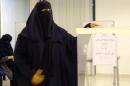 A Saudi woman casts her ballot in the capital Riyadh on December 12, 2015 as the nation allowed women to vote for the first time