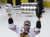Chicago Blackhawks' Jonathan Toews hoists the Stanley Cup after defeating the Boston Bruins 3-2 in Game 6 to win the NHL hockey Stanley Cup Finals, Monday, June 24, 2013, in Boston. (AP Photo/Charles Krupa)