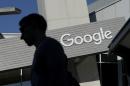 FILE - In this Nov. 12, 2015, file photo, a man walks past a building on the Google campus in Mountain View, Calif. Google said Wednesday, May 11, 2016, that it will ban ads from payday lenders, calling the industry 