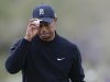 Tiger Woods tips his hat to fans after putting on the 11th green in the first round against Charles Howell III during the Match Play Championship golf tournament, Thursday, Feb. 21, 2013, in Marana, Ariz. (AP Photo/Ted S. Warren)