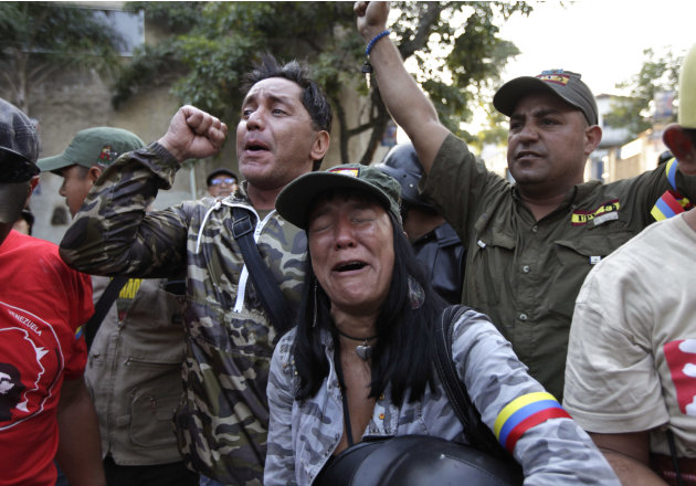 Supporters of Venezuela's President Hugo Chavez react as they learn that Chavez has died through an announcement by the vice president in Caracas, Venezuela, Tuesday, March 5, 2013. Venezuela's Vice P