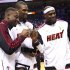 From left, Miami Heat's Dwyane Wade, Chris Bosh and LeBron James pose with their 2012 NBA Finals championship rings during a ceremony before a basketball game against the Boston Celtics, Tuesday, Oct. 30, 2012, in Miami. (AP Photo/J Pat Carter)