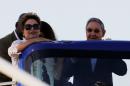 File photo of Brazil's President Rousseff and her Cuban counterpart Castro aboard a tour bus during the inauguration of a port in Mariel on the outskirts of Havana