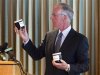 Newspaper publisher David Black holds jars of diluted bitumen while announcing a plan to potentially build a $13 billion dollar oil refinery in Kitimat, B.C in Vancouver