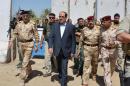 A handout picture released by the Iraqi prime minister's media office shows PM Nuri al-Maliki touring military posts in the outskirts of Baghdad on August 6, 2013