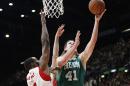 Boston Celtics' Kelly Olynyk, right, challenges for the ball with Olimpia Milano's Gani Lawal during their basketball match, part of the NBA global games, in Assago, near Milan, Italy, Tuesday, Oct. 6, 2015. (AP Photo/Antonio Calanni)