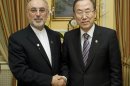 In this photo provided by the United Nations, Iranian Foreign Minister Ali Akbar Salehi, left, poses with United Nations Secretary General Ban Ki-moon at the Sacher Hotel in Vienna, Austria, Wednesday, Feb. 27, 2013. (AP Photo/The United Nations, Evan Schneider)
