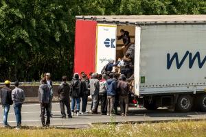 Migrants pictured in June climbing into lorry on highway&nbsp;&hellip;