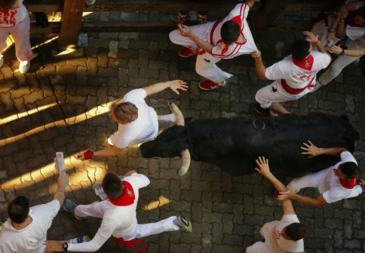 Revelers are chased by Fuente Ymbro's ranch fighting bulls in the 2016 San Fermin fiestas in Pamplona, Spain