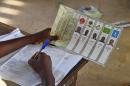 A member of Togo's electoral commission counts ballots for the presidential election vote at a polling station on April 25, 2015 in Lome