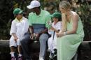 Lindsey Vonn sits with Tiger Woods with his children Sam and Charlie during the Par 3 contest at the Masters golf tournament Wednesday, April 8, 2015, in Augusta, Ga. (AP Photo/David J. Phillip)