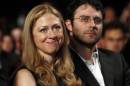 File picture shows Chelsea Clinton sitting with her husband Marc Mezvinsky as U.S. President Barack Obama speaks at the Clinton Global Initiative in New York