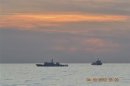 A handout photo shows two Chinese surveillance ships which sailed between a Philippines warship and eight Chinese fishing boats to prevent the arrest of any fishermen in the Scarborough Shoal, a small group of rocky formations whose sovereignty is contested by the Philippines and China, in the South China Sea, about 124 nautical miles off the main island of Luzon in this April 10, 2012 file photo.